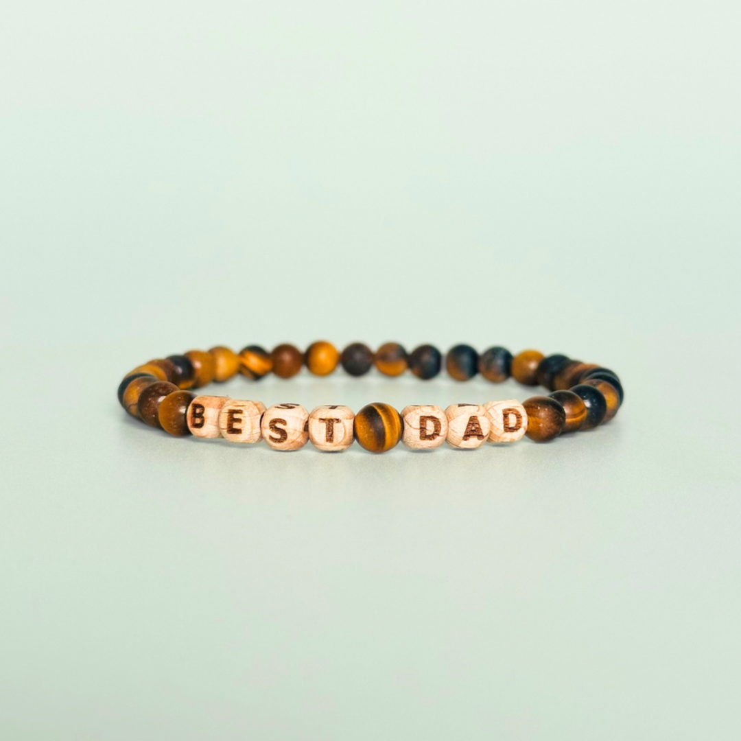Men’s crystal bracelet with 6mm frosted tigers eye gemstone crystal beads and laser engraved wooden letter beads featuring the words best dad or can also be made with any other words or letters.