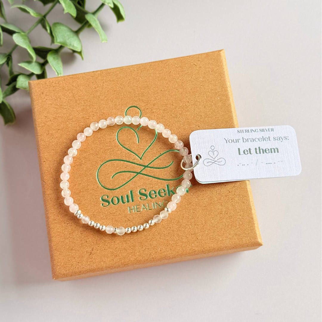 Rose quartz crystal morse code bracelet that spells out the words ‘Let them’ in a combination of 4mm round rose quartz beads, 4mm faceted rose quartz beads and either sterling silver or gold vermeil 3mm round beads. The words start and end at the rondelle spacer beads.
