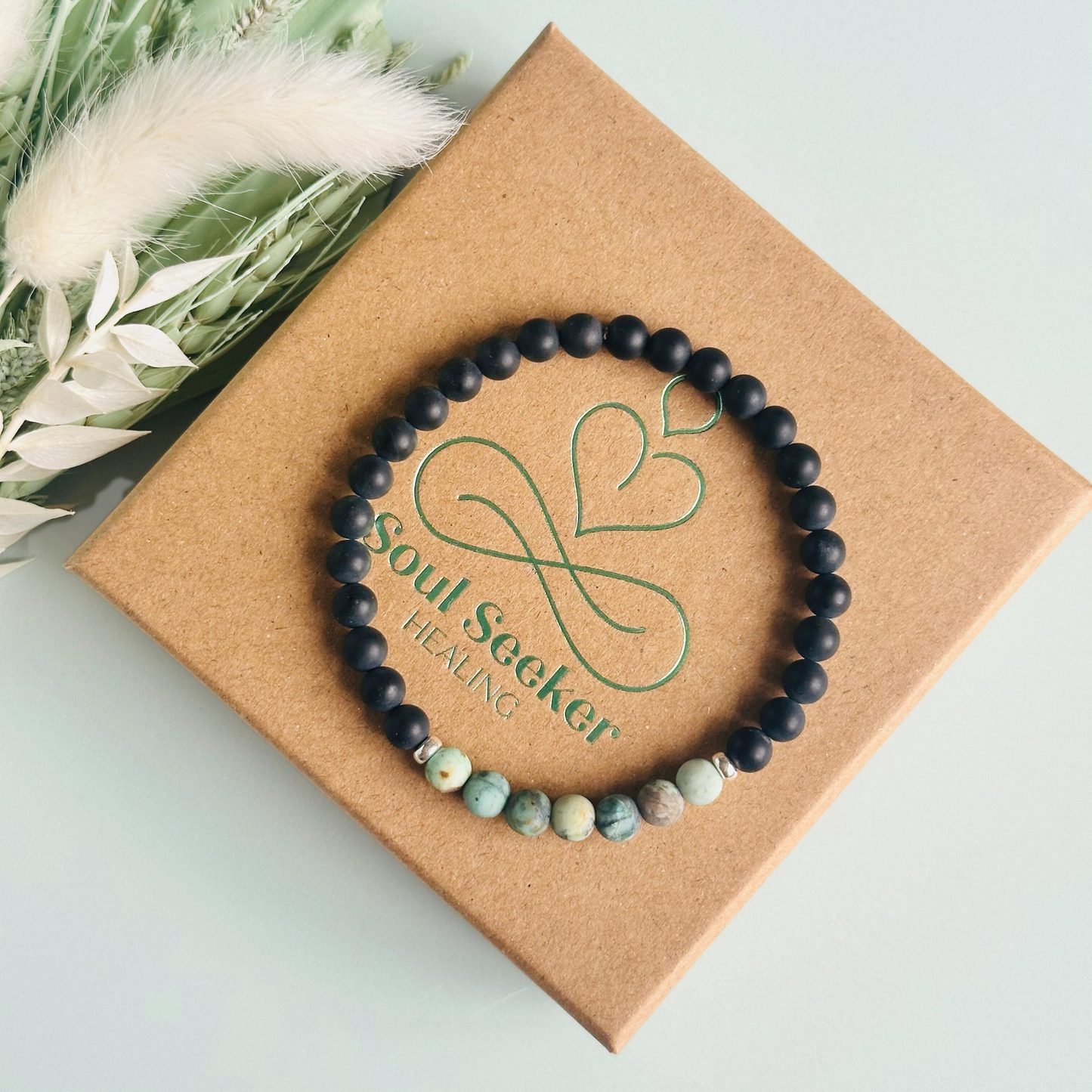 Men’s crystal bracelet featuring 6mm matte black onyx beads, 6mm matte African turquoise beads with sterling silver spacer beads.