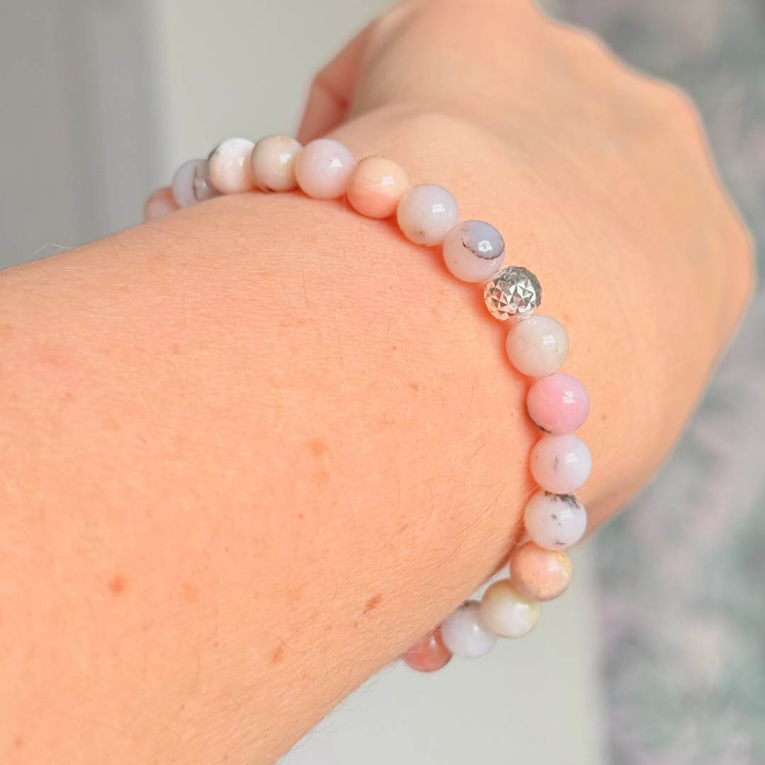 Pink opal bracelet featuring 6mm genuine round pink opal beads, with one faceted gold vermeil 6mm bead as the focal point. Elasticated for comfort.