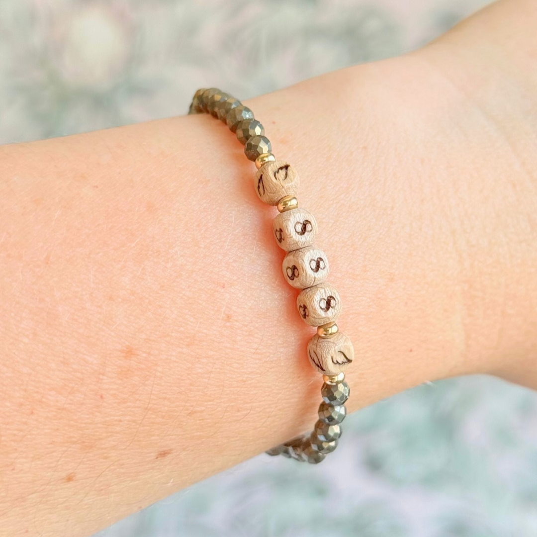 Bracelet featuring engraved wooden 888 angel number and wing beads, on the band of 4mm faceted pyrite round crystal gemstone beads. Finished with your choice of gold vermeil, sterling silver or rose gold vermeil accent beads.