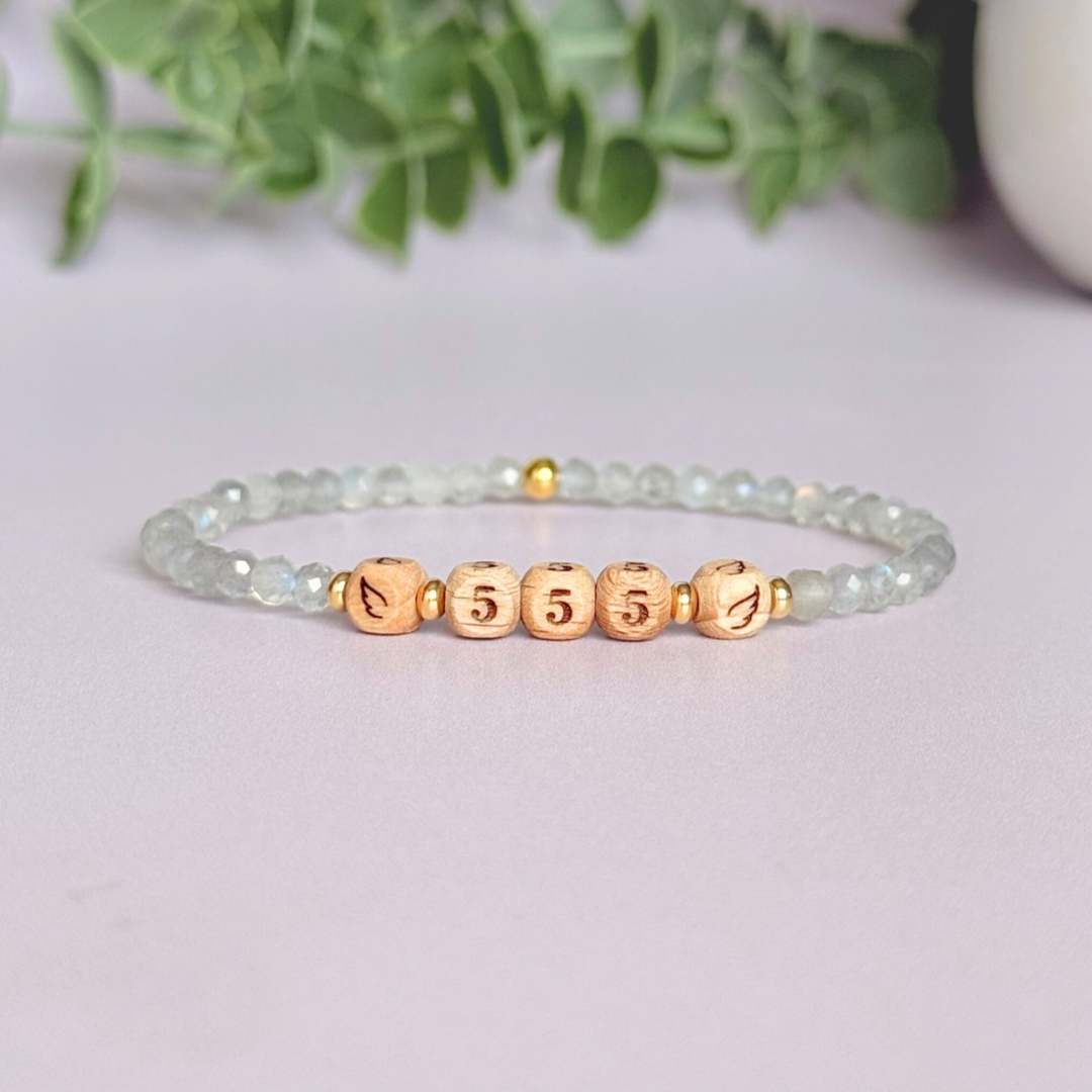 Bracelet featuring engraved wooden 555 angel number and wing beads, on the band of 4mm faceted labradorite round crystal gemstone beads. Finished with your choice of gold vermeil, sterling silver or rose gold vermeil accent beads.