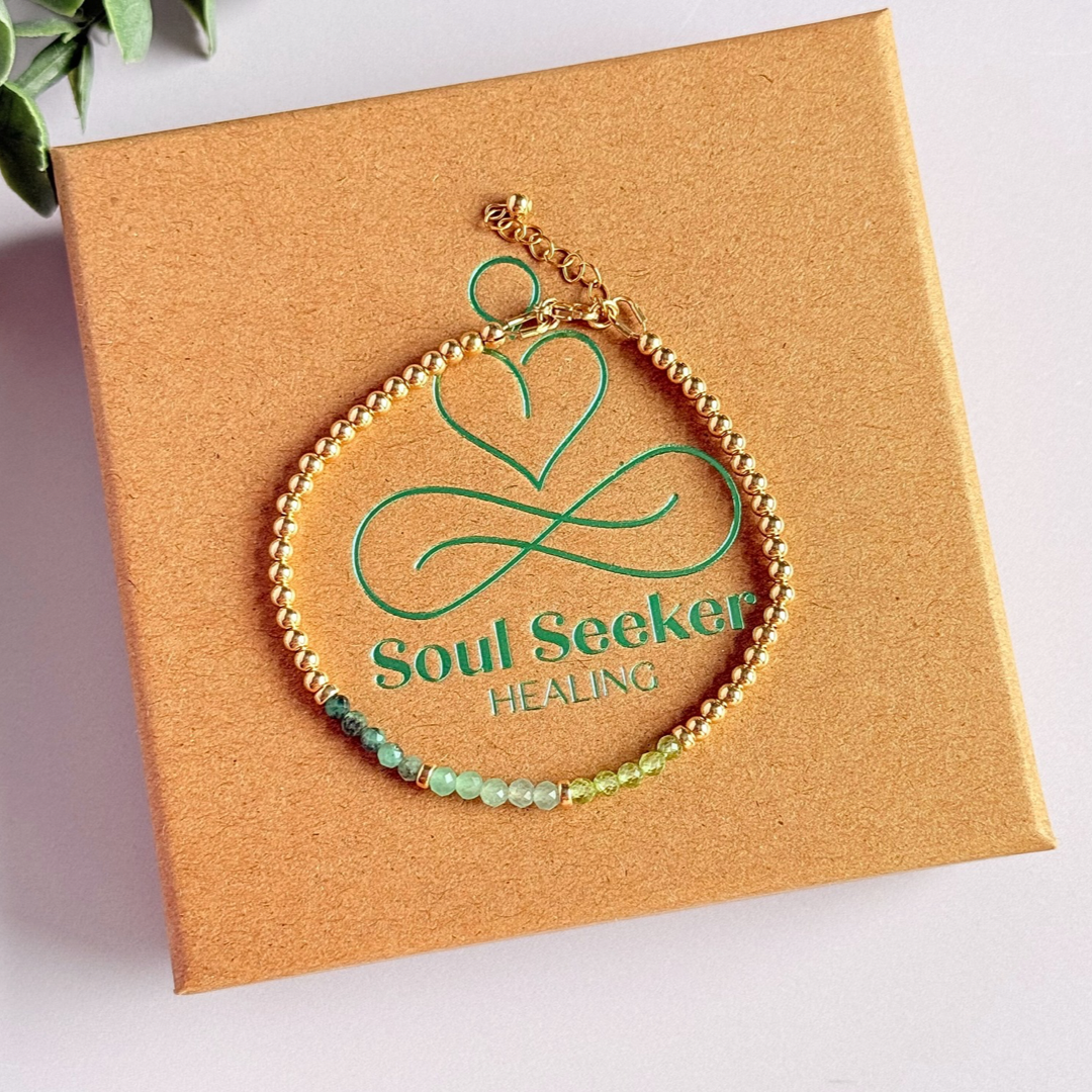 Dainty minimalist yellow gold filled crystal bracelet featuring 3mm faceted emerald, peridot and green aventurine beads in a colour block Ombre style. Fastens with a gold filled lobster clasp with an extender chain.