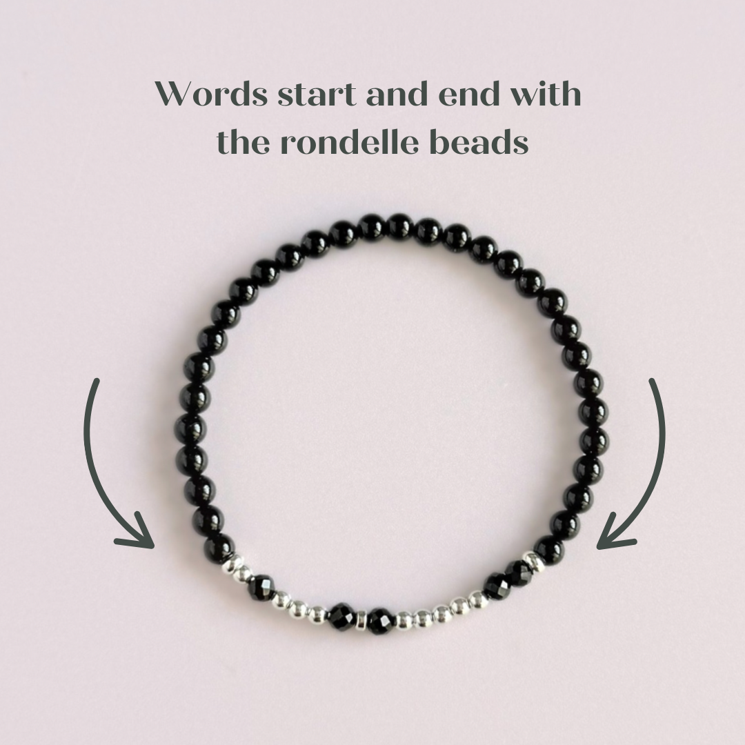 Black tourmaline crystal morse code bracelet that spells out the words ‘Let them’ in a combination of 4mm round black tourmaline beads, 4mm faceted black tourmaline beads and either sterling silver or gold vermeil 3mm round beads. The words start and end at the rondelle spacer beads.