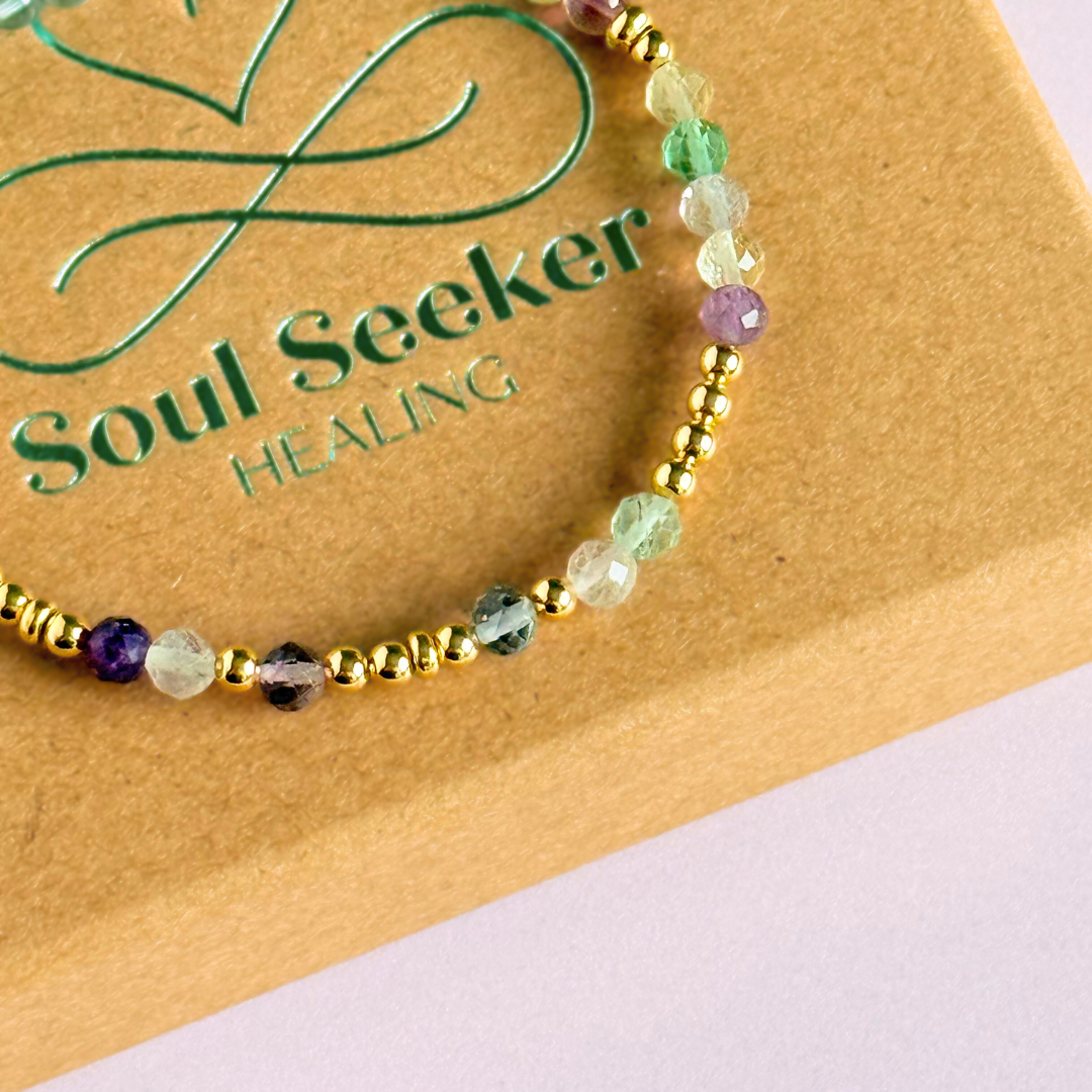 Elasticated stretch fluorite crystal morse code bracelet spelling out the words ‘ADHD and awesome’ in a combination of 4mm round fluorite beads, 4mm faceted fluorite beads and either sterling silver or gold vermeil 3mm round beads. The words start and end at the rondelle spacer beads.