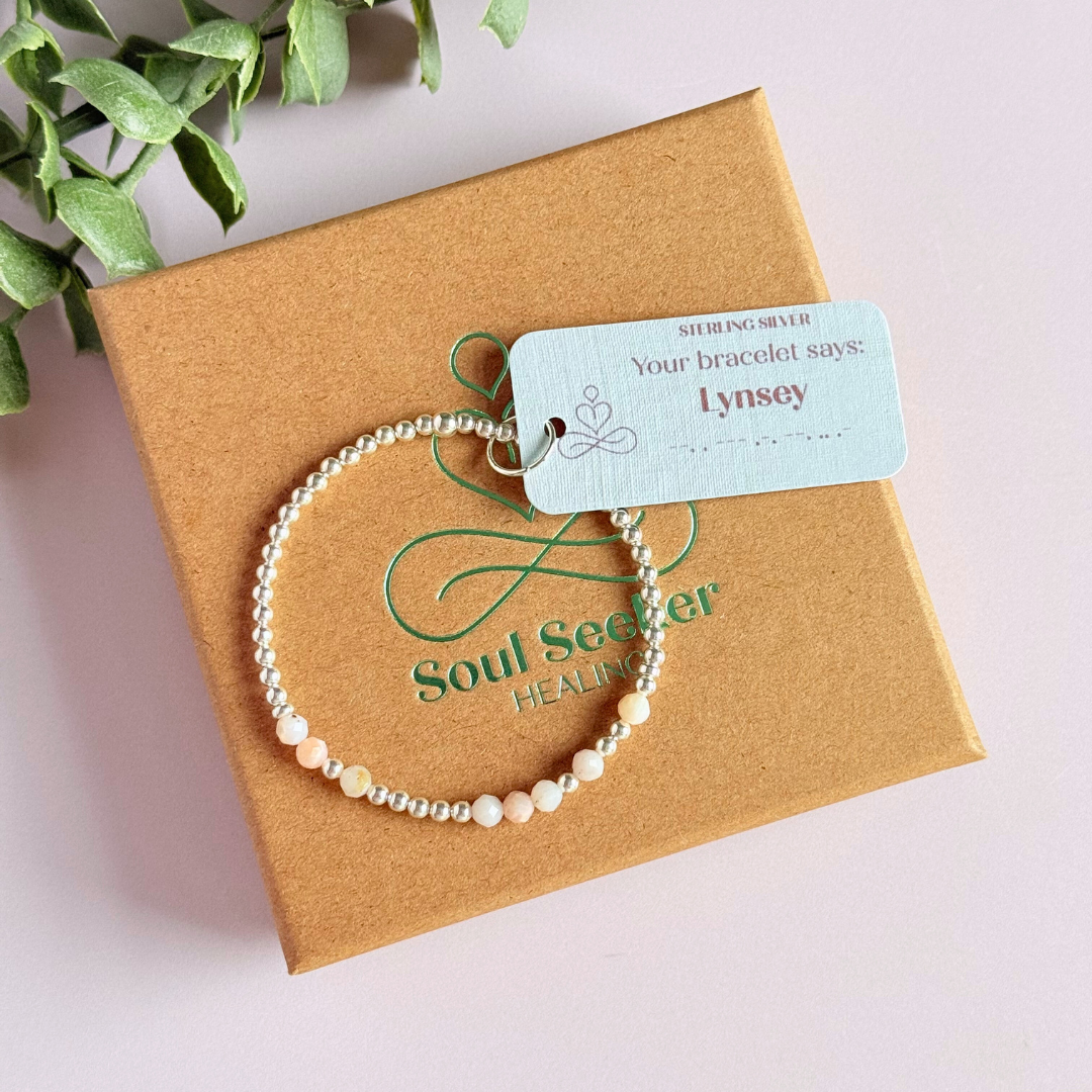 Morse code secret message bracelet spelling out your chosen name in sterling silver and pink opal crystal beads. Elasticated with 4mm faceted pink opal beads and 3mm sterling silver beads. Custom October birthstone bracelet.