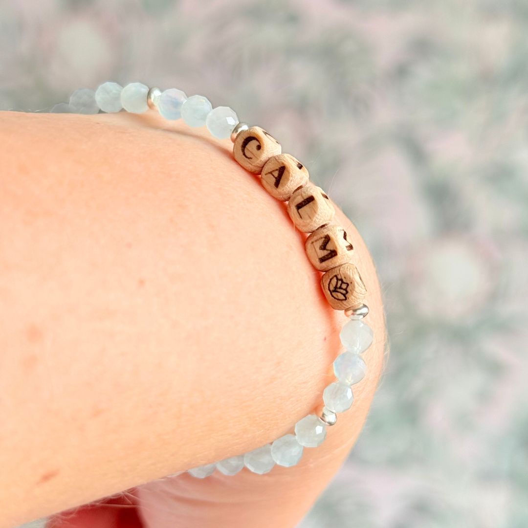 Bracelet featuring 5mm engraved wooden beads which you can personalise with your choice of words, numbers and symbols. The main the band of the bracelet is made with 4mm faceted aquamarine round crystal gemstone beads. Finished with your choice of gold vermeil, sterling silver or rose gold vermeil accent beads.