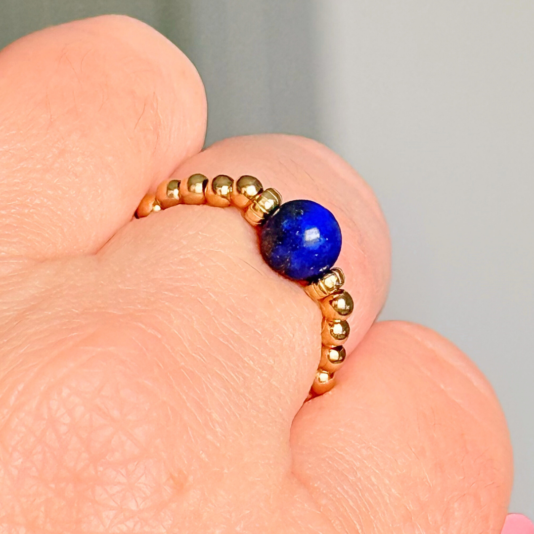 Gold vermeil beaded ring featuring a 6mm lapis lazuli round bead, flanked by gold vermeil corrugated beads. Elasticated for comfort.