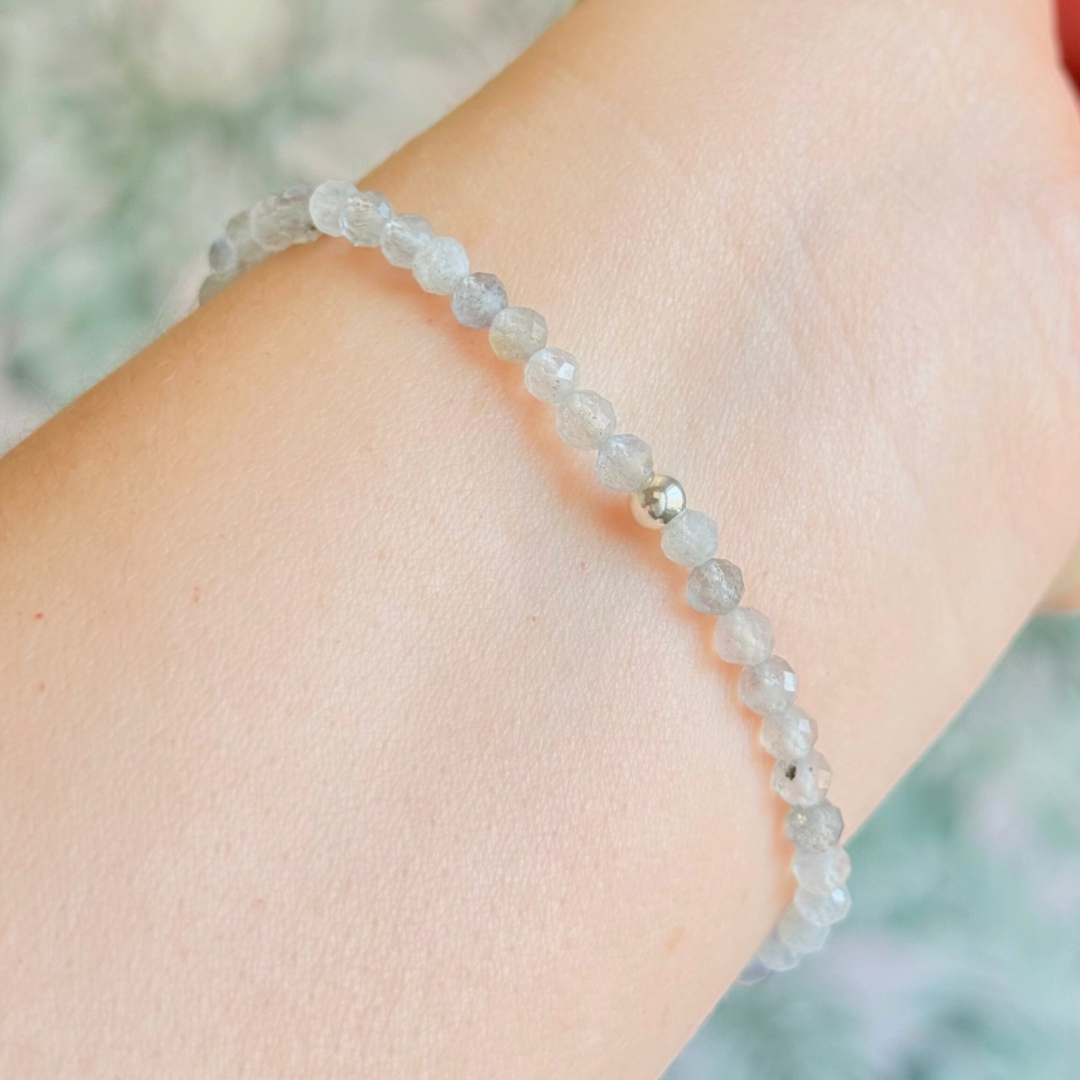 Bracelet featuring engraved wooden 555 angel number and wing beads, on the band of 4mm faceted labradorite round crystal gemstone beads. Finished with your choice of gold vermeil, sterling silver or rose gold vermeil accent beads.
