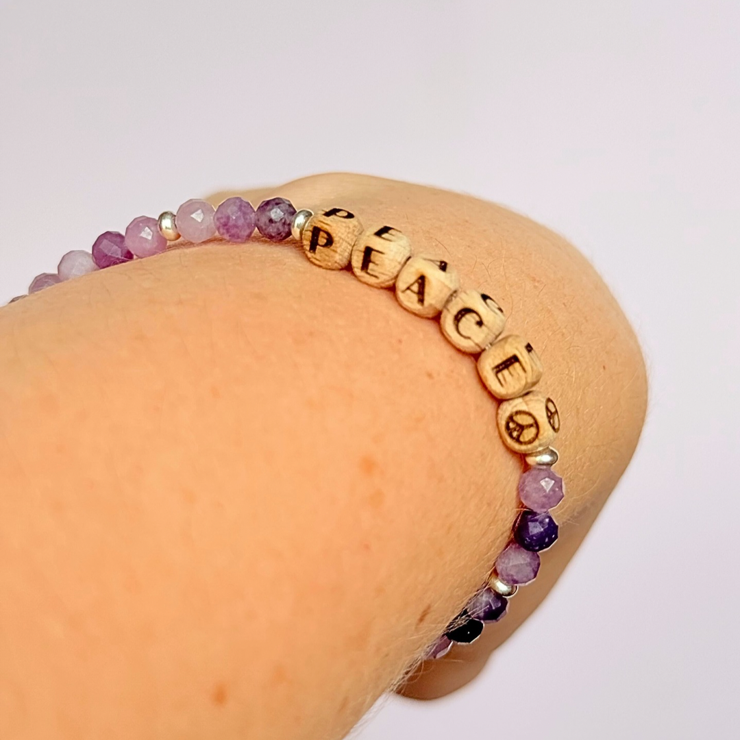 Bracelet featuring 5mm engraved wooden beads which you can personalise with your choice of words, numbers and symbols. The main the band of the bracelet is made with 4mm faceted lepidolite round crystal gemstone beads. Finished with your choice of gold vermeil, sterling silver or rose gold vermeil accent beads.