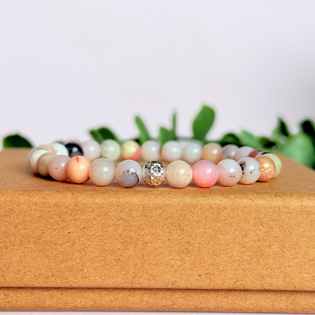 Pink opal bracelet featuring 6mm genuine round pink opal beads, with one faceted gold vermeil 6mm bead as the focal point. Elasticated for comfort.