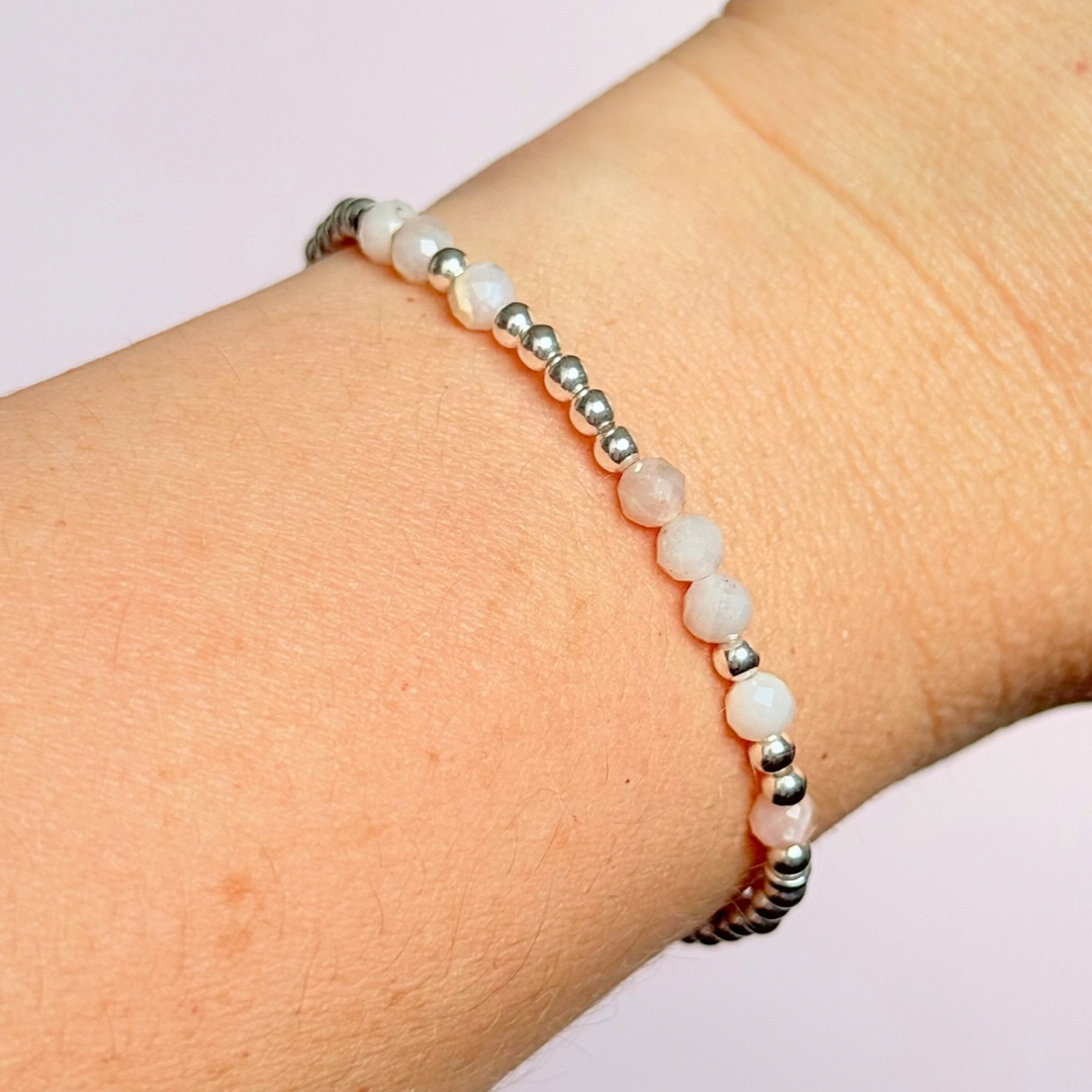 Morse code secret message bracelet spelling out your chosen name in sterling silver and pink opal crystal beads. Elasticated with 4mm faceted pink opal beads and 3mm sterling silver beads. Custom October birthstone bracelet.