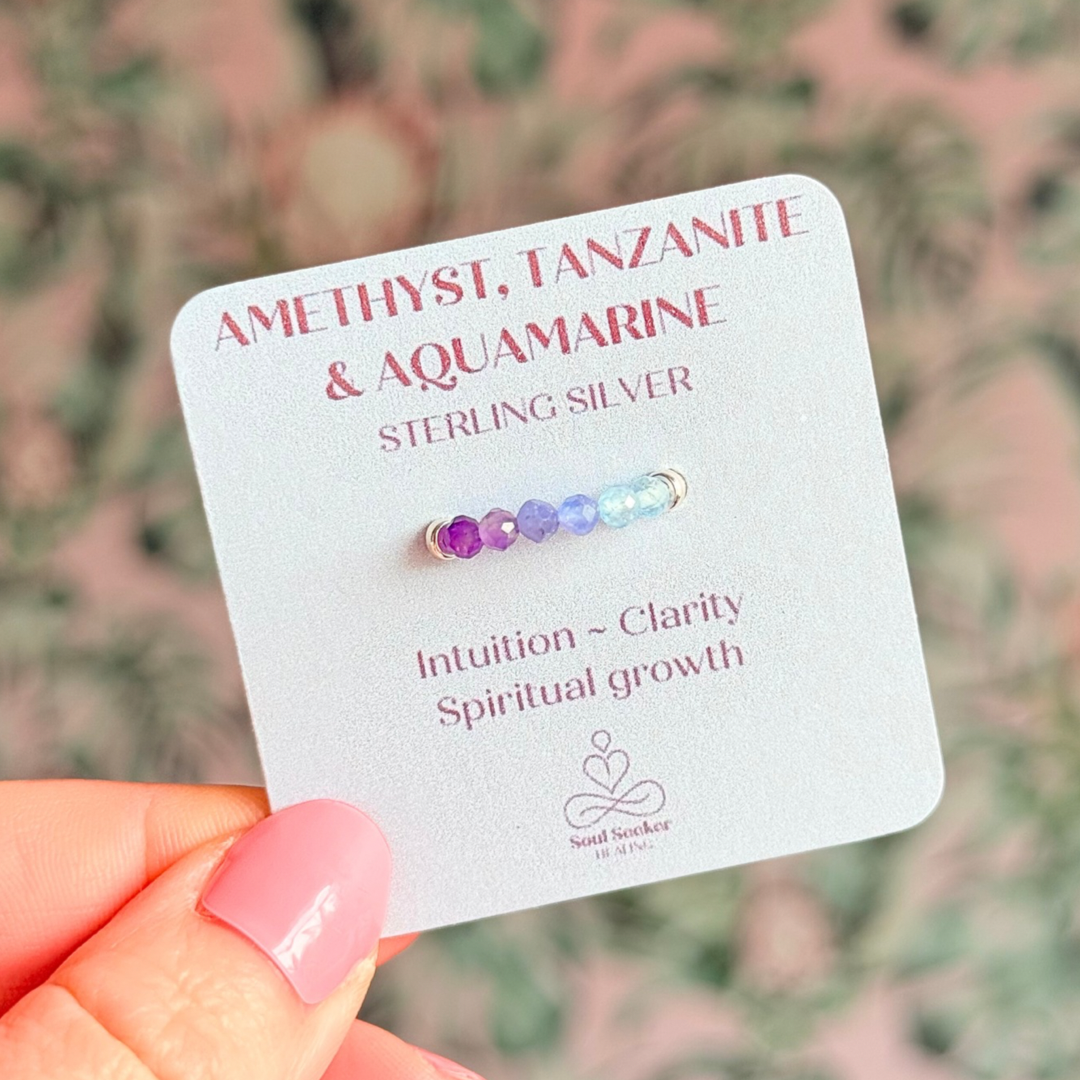 Sterling silver band style ombré ring with multicolour 3mm faceted amethyst tanzanite and aquamarine, beads with a beaded band of 2.5 mm sterling silver round beads. Elasticated for comfort.