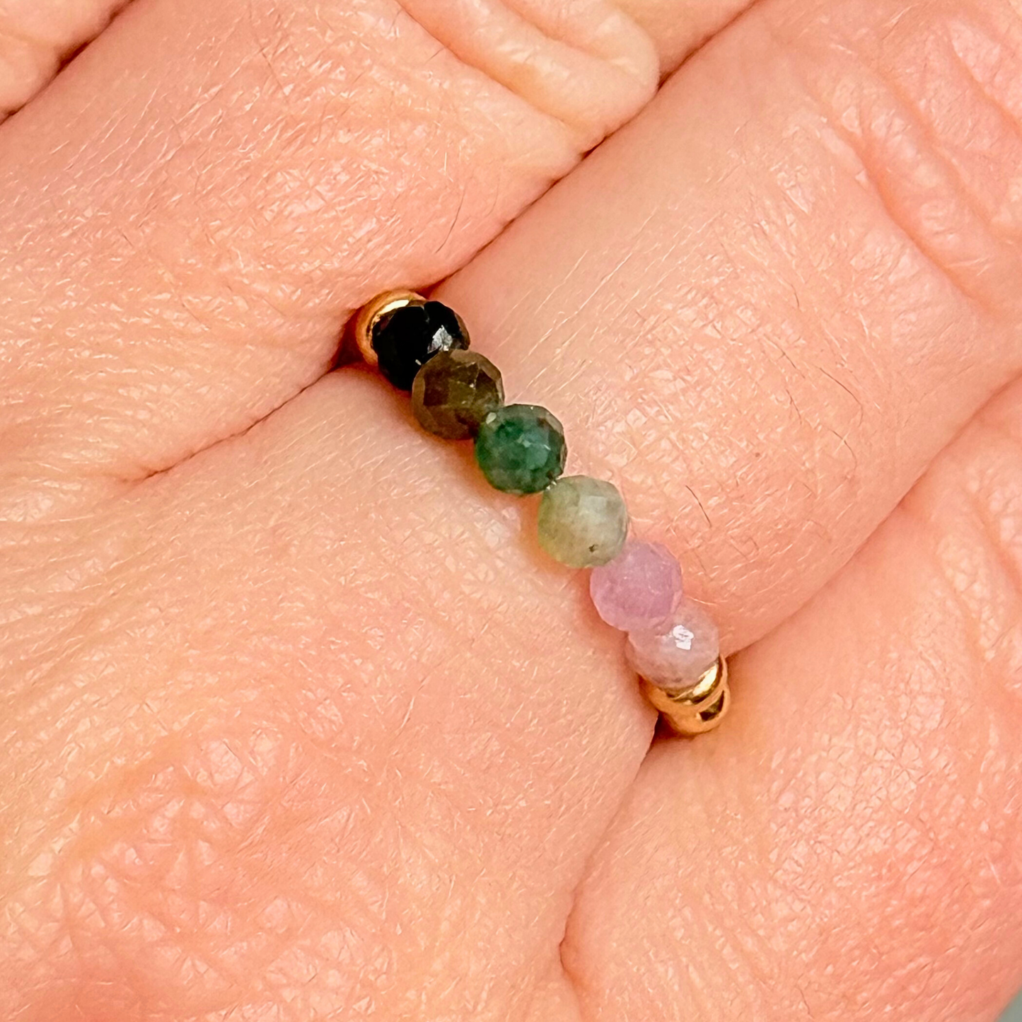 Gold vermeil band style ring with multicolour 3mm faceted mixed tourmaline beads in shades of pink, green and black, with a beaded band of 2.5 mm gold vermeil round beads. Elasticated for comfort.