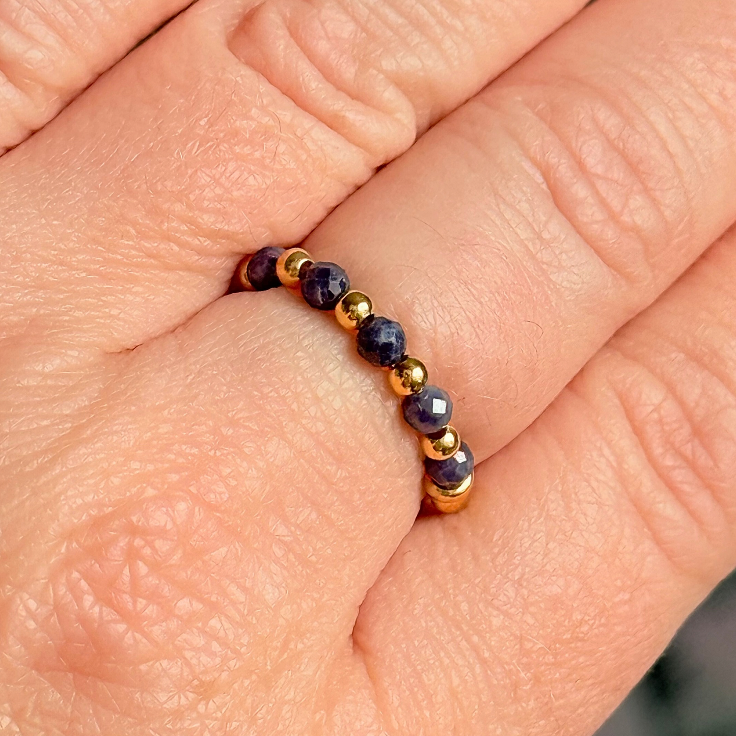 Gold vermeil and sapphire crystal ring. Made with 2.5mm gold vermeil round beads and featuring five, 3mm faceted genuine sapphire beads in a band style. Perfect for stacking. September birthstone jewellery