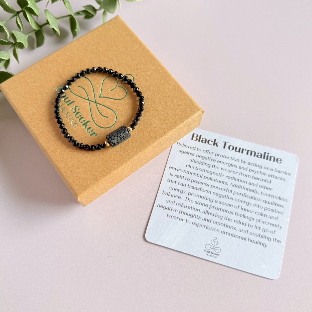 Essential oil diffuser bracelet featuring black lava rock tube bead on the band of 4mm faceted black tourmaline beads. Finished with your choice of sterling silver or gold vermeil accent beads.