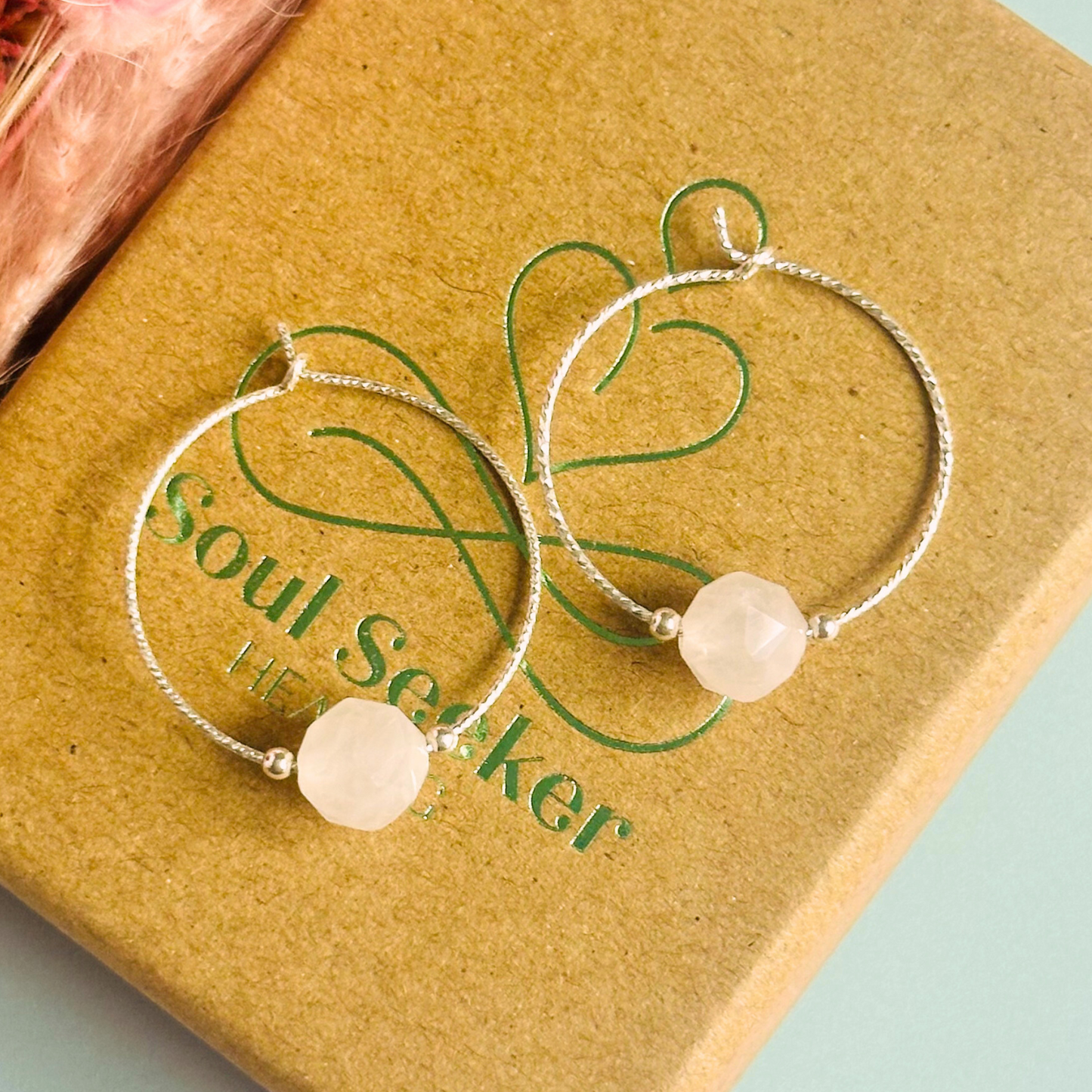 Rose Quartz sterling silver hoop earrings featuring 8mm star cut rose quartz beads on 25mm sparkle cut sterling silver hoops.