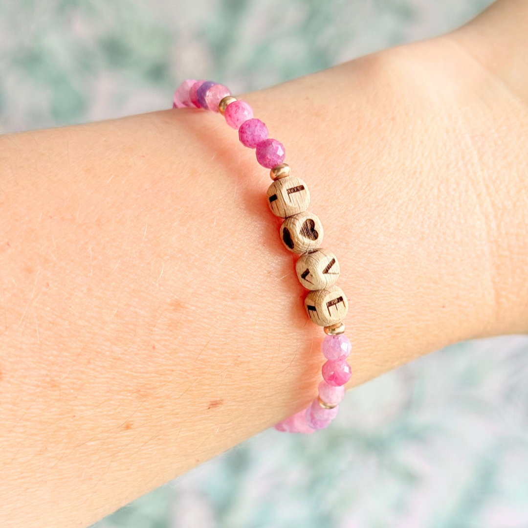 Bracelet featuring 5mm engraved wooden beads which you can personalise with your choice of words, numbers and symbols. The main the band of the bracelet is made with 4mm faceted pink tourmaline round crystal gemstone beads. Finished with your choice of gold vermeil, sterling silver or rose gold vermeil accent beads.