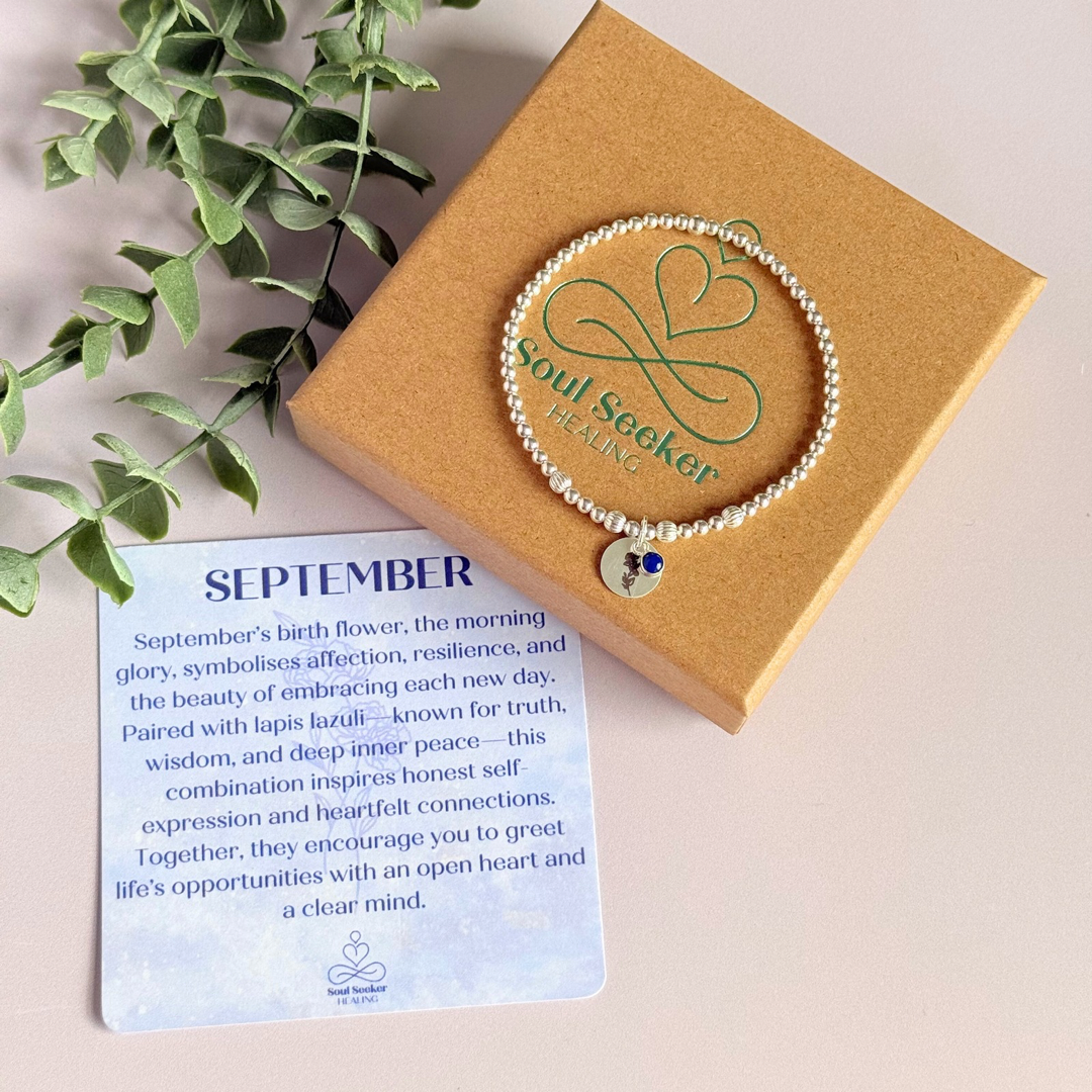 This sterling silver bracelet features a domed 4mm lapis lazuli cabochon charm, the birth stone for September, in a sterling silver setting. It features an 11mm sterling silver disc charm, which is engraved with the September birth flower, Morning Glory. This charm can be personalised on one side if required or feature the same flower graphic on both sides. The main band of the bracelet is made up of 3 mm sterling silver round ball beads with some corrugated accent beads.