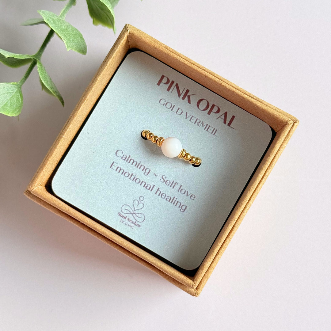 Gold vermeil pink opal October birthstone ring featuring a 6mm smooth, round pink opal bead on a band of 2.5mm gold vermeil ball beads. Elasticated for comfort.