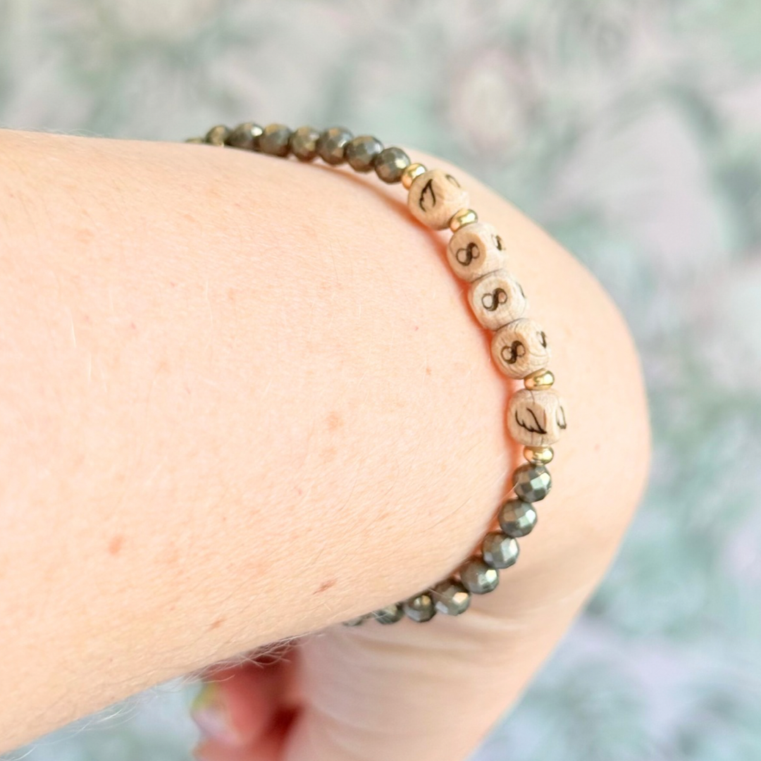 Bracelet featuring engraved wooden 888 angel number and wing beads, on the band of 4mm faceted pyrite round crystal gemstone beads. Finished with your choice of gold vermeil, sterling silver or rose gold vermeil accent beads.