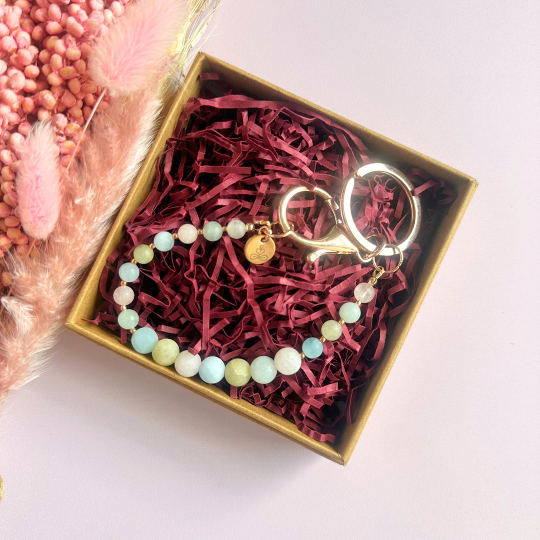 Frosted morganite breath work beads on a rose gold keychain/bag charm. For the 4-7-8 counted breathing method.