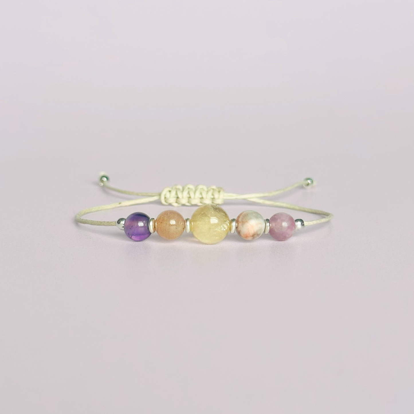 Menopause crystal healing bracelet made with the lepidolite, peach moonstone, citrine, pink zebra jasper and amethyst. Strung on an eco and vegan friendly waxed cotton cord and finished with your choice of sterling silver, rose gold vermeil or gold vermeil accent beads. A sliding macramé clasp makes it adjustable.