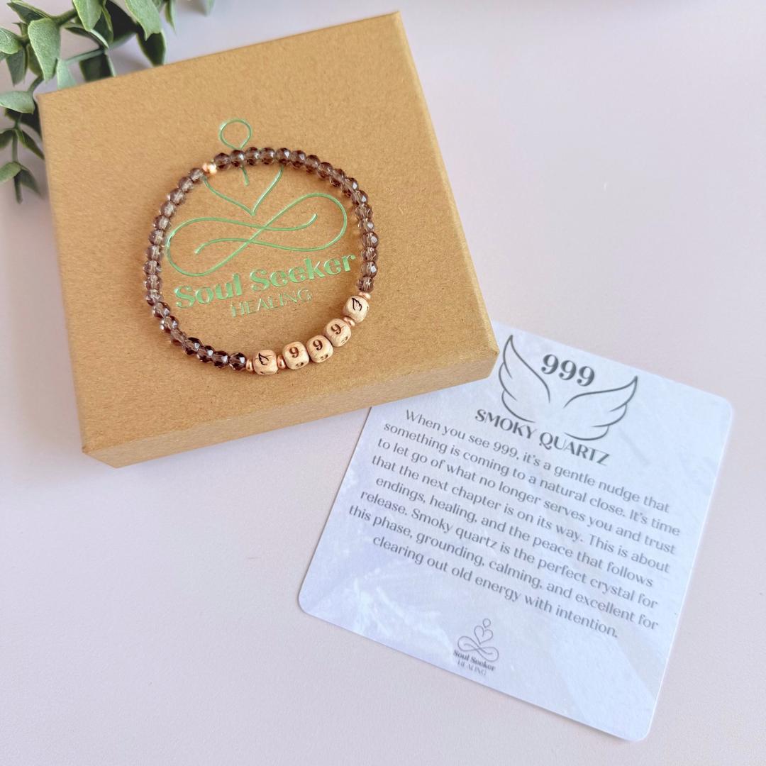 Bracelet featuring engraved wooden 999 angel number and wing beads, on the band of 4mm faceted smoky quartz round crystal gemstone beads. Finished with your choice of gold vermeil, sterling silver or rose gold vermeil accent beads.
