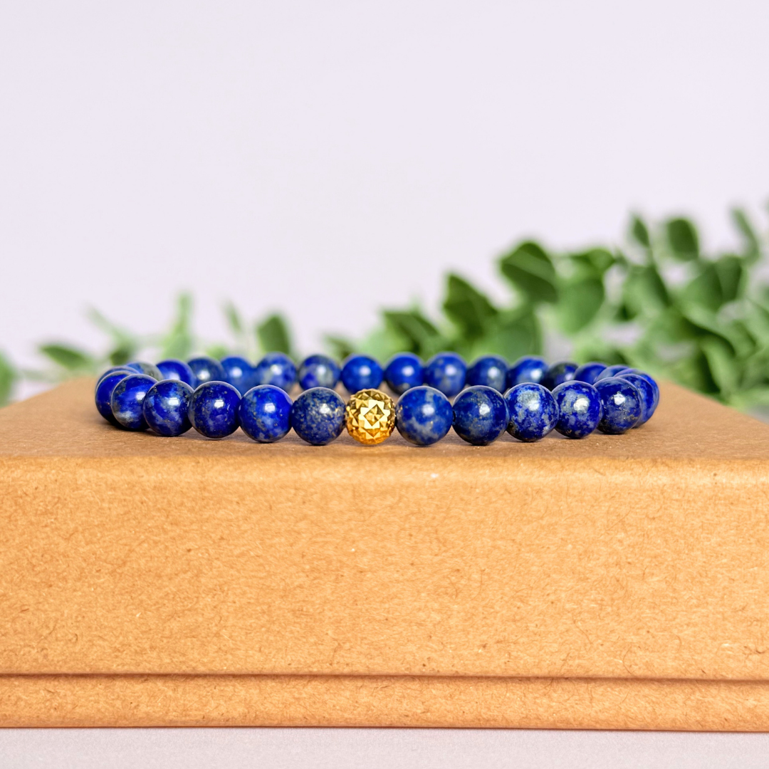 Genuine lapis lazuli bracelet featuring 6mm, smooth, round dark blue lapis lazuli beads and your choice of a 6mm faceted gold vermeil or sterling silver accent bead. Elasticated for comfort.