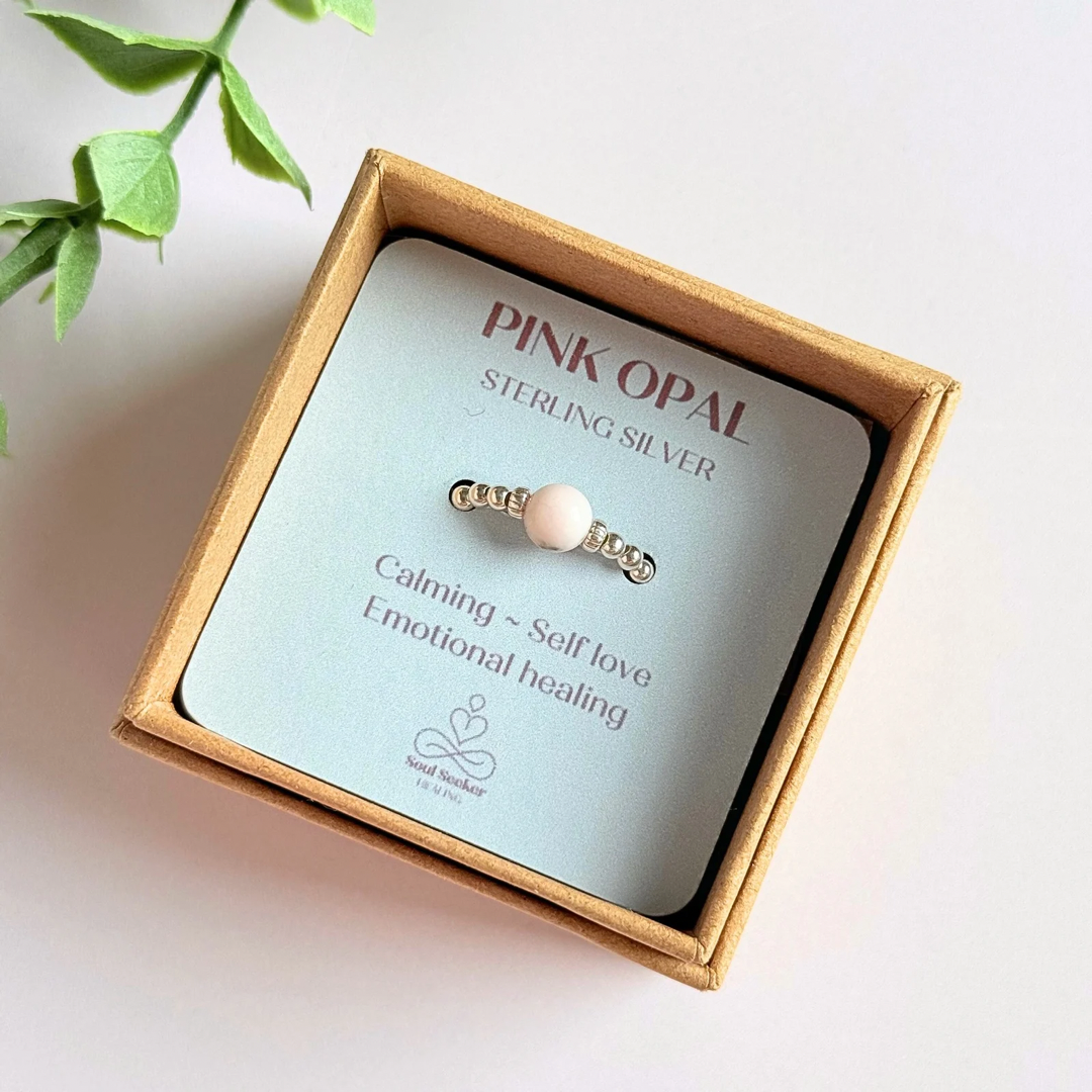 Sterling silver pink opal October birthstone ring featuring a 6mm smooth, round pink opal bead on a band of 2.5mm sterling silver ball beads. Elasticated for comfort.