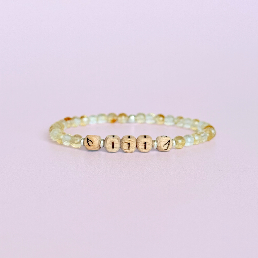Bracelet featuring engraved wooden 111 angel number and wing beads, on the band of 4mm faceted citrine round crystal gemstone beads. Finished with your choice of gold vermeil, sterling silver or rose gold vermeil accent beads.