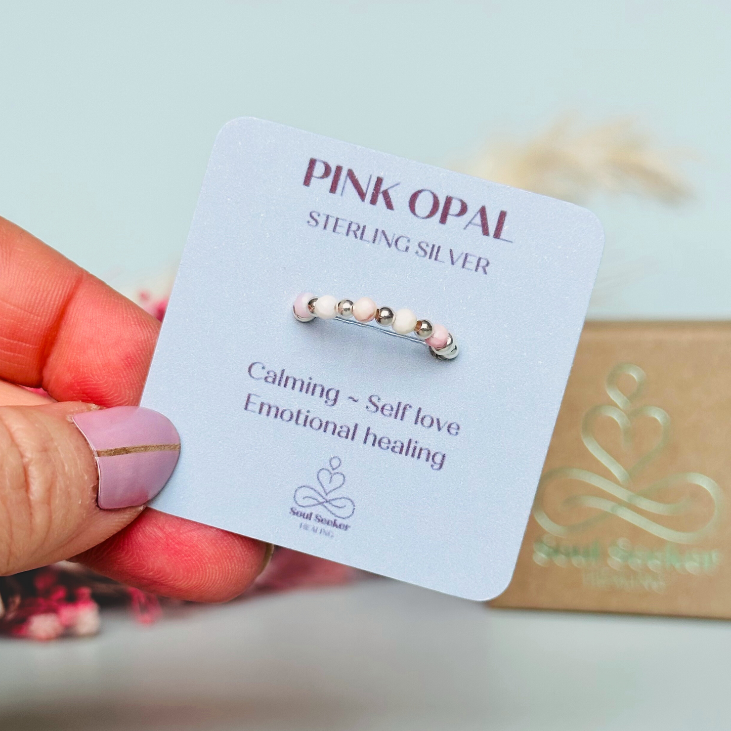 Birthstone ring featuring 5 3mm. Faceted Peruvian pink opal beads on an elasticated band of 3mm sterling silver round beads, pink opal is an October birth stone so this makes a perfect October birthday gift.