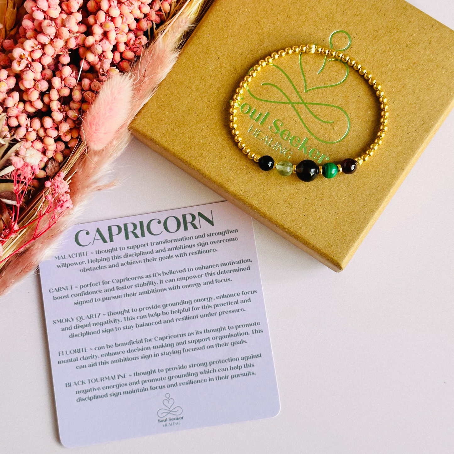 This gold vermeil Capricorn bracelet is made with a selection of five healing crystals all believed to resonate with the Capricorn zodiac sign. The central bead is 8mm, the other four are 6mm. On an elasticated band of 3mm gold vermeil beads with corrugated accent beads. Featuring garnet, malachite, fluorite, smoky quartz and black tourmaline.
