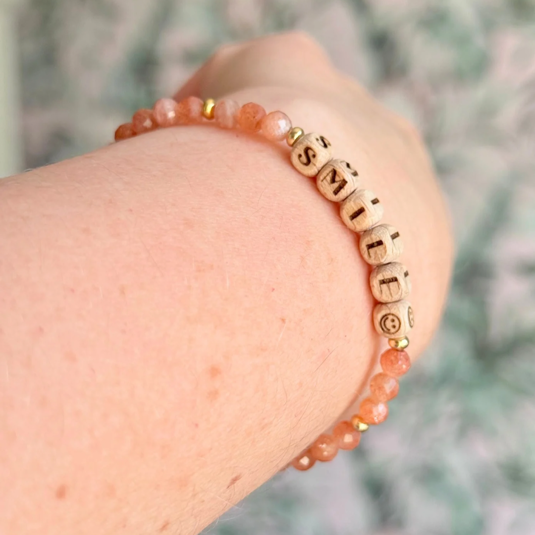 Bracelet featuring 5mm engraved wooden beads which you can personalise with your choice of words, numbers and symbols. The main the band of the bracelet is made with 4mm faceted sunstone round crystal gemstone beads. Finished with your choice of gold vermeil, sterling silver or rose gold vermeil accent beads.