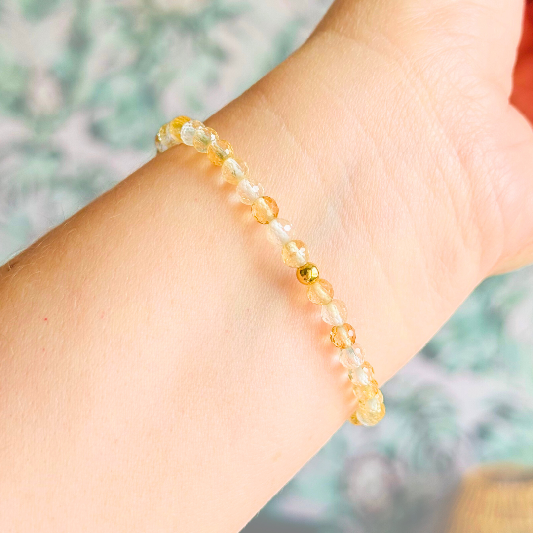 Bracelet featuring engraved wooden 111 angel number and wing beads, on the band of 4mm faceted citrine round crystal gemstone beads. Finished with your choice of gold vermeil, sterling silver or rose gold vermeil accent beads.