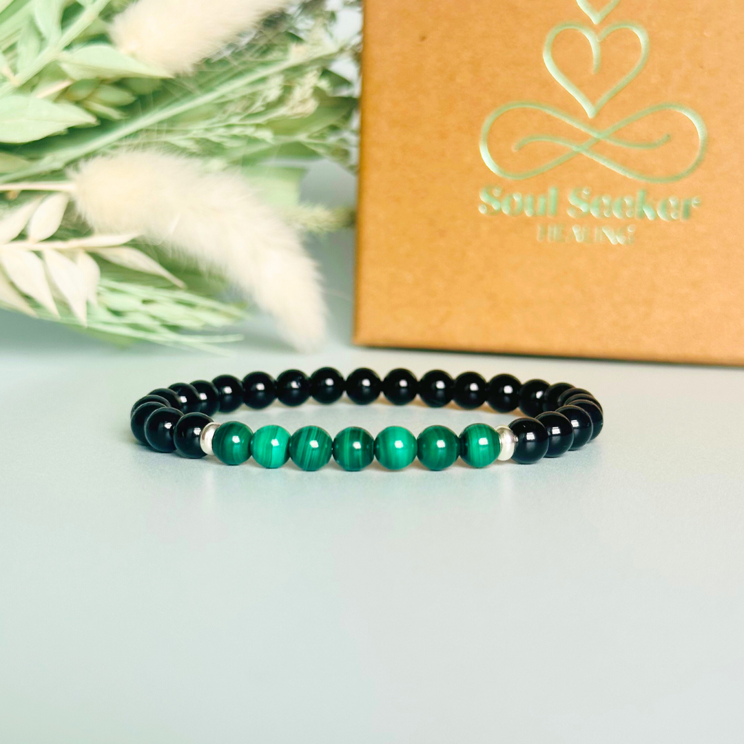 Mens crystal bracelet featuring 6mm black tourmaline beads with 6mm malachite beads, separated by two sterling silver spacer beads.
