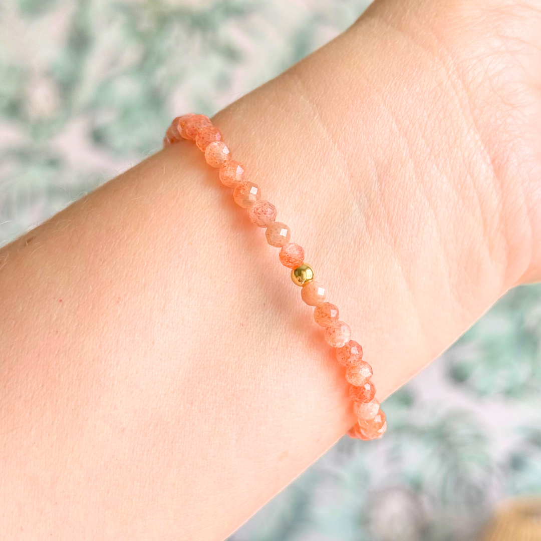 Bracelet featuring engraved wooden 111 angel number and wing beads, on the band of 4mm faceted sunstone round crystal gemstone beads. Finished with your choice of gold vermeil, sterling silver or rose gold vermeil accent beads.
