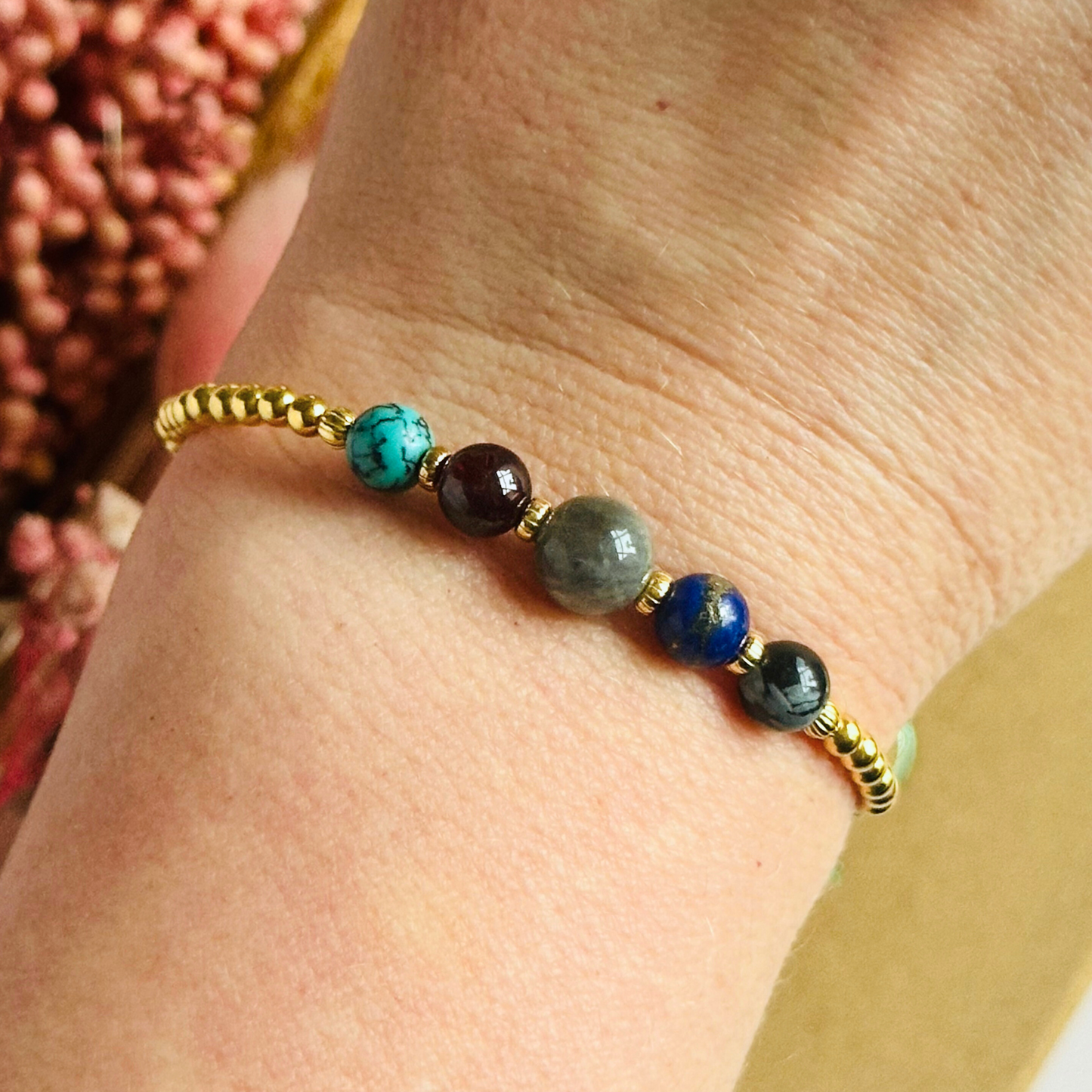 This gold vermeil Sagittarius bracelet is made with a selection of five healing crystals all believed to resonate with the Sagittarius zodiac sign. The central bead is 8mm, the other four are 6mm. On an elasticated band of 3mm gold vermeil beads with corrugated accent beads. Featuring garnet, labradorite, lapis lazuli, snowflake obsidian and turquoise.