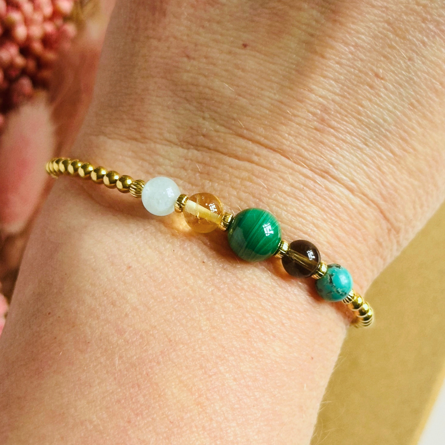 This gold vermeil Scorpio bracelet is made with a selection of five healing crystals all believed to resonate with the Scorpio zodiac sign. The central bead is 8mm, the other four are 6mm. On an elasticated band of 3mm gold vermeil beads with corrugated accent beads. Featuring aquamarine, citrine, malachite, smoky quartz and turquoise.