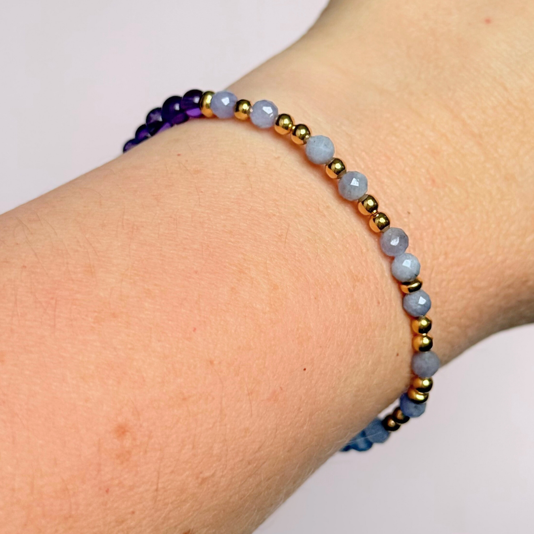 Amethyst and tanzanite elasticated stretch crystal morse code bracelet that spells out the words ‘Calm TF down’ in a combination of 4mm round amethyst beads, 4mm faceted tanzanite beads and either sterling silver or gold vermeil 3mm round beads. The words start and end at the rondelle spacer beads.