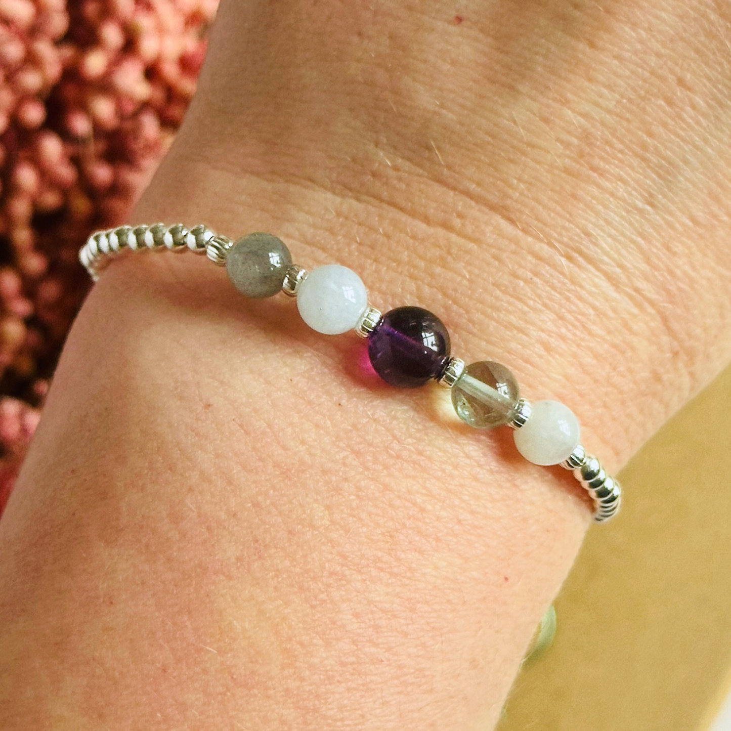 This sterling silver Aquarius bracelet is made with a selection of five healing crystals all believed to resonate with the Aquarius zodiac sign. The central bead is 8mm, the other four are 6mm. On an elasticated band of 3mm sterling silver beads with corrugated accent beads. Featuring labradorite, moonstone, fluorite, amethyst and aquamarine.