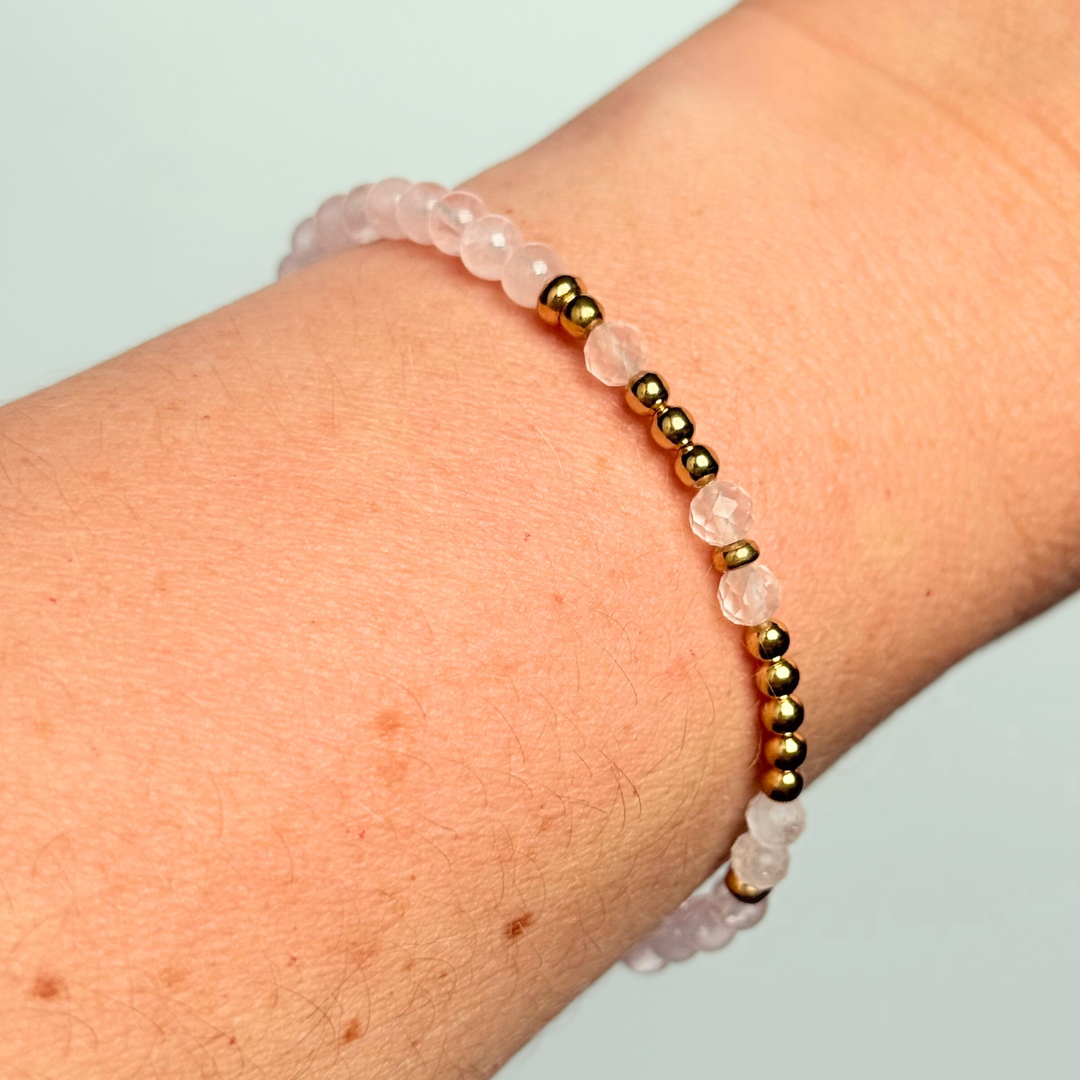 Rose quartz crystal morse code bracelet that spells out the words ‘Let them’ in a combination of 4mm round rose quartz beads, 4mm faceted rose quartz beads and either sterling silver or gold vermeil 3mm round beads. The words start and end at the rondelle spacer beads.