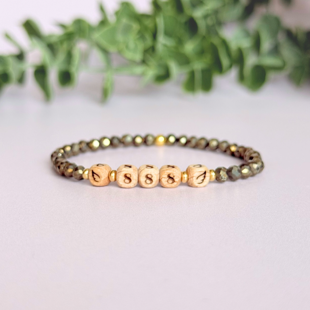 Bracelet featuring engraved wooden 888 angel number and wing beads, on the band of 4mm faceted pyrite round crystal gemstone beads. Finished with your choice of gold vermeil, sterling silver or rose gold vermeil accent beads.