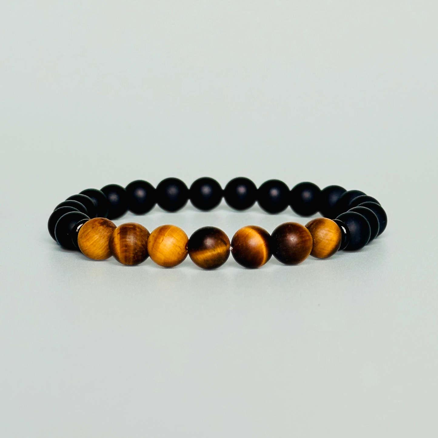 Men’s crystal bracelet featuring 8mm matte black onyx beads, 8mm matte tigers eye beads with black agate spacer beads.