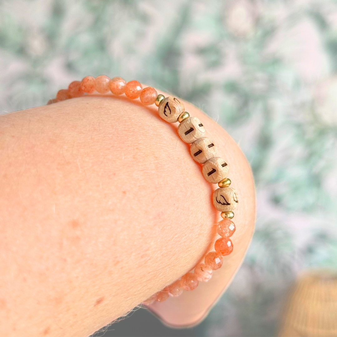 Bracelet featuring engraved wooden 111 angel number and wing beads, on the band of 4mm faceted sunstone round crystal gemstone beads. Finished with your choice of gold vermeil, sterling silver or rose gold vermeil accent beads.