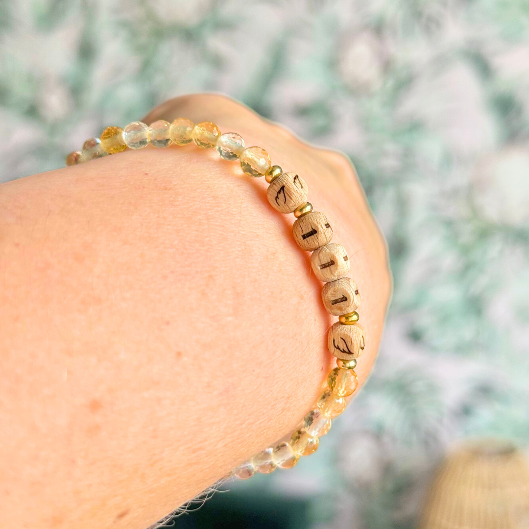 Bracelet featuring engraved wooden 111 angel number and wing beads, on the band of 4mm faceted citrine round crystal gemstone beads. Finished with your choice of gold vermeil, sterling silver or rose gold vermeil accent beads.