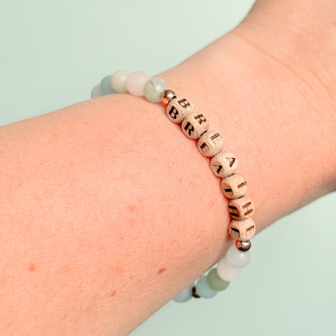 Breathwork bracelet featuring 6mm and 8mm frosted crystal beads that follow the 4-7-8 counted breathing method. Also featuring laser engraved wooden letter beads spelling out the word BREATHE. Choose your accent beads from rose gold vermeil, gold vermeil or sterling silver.