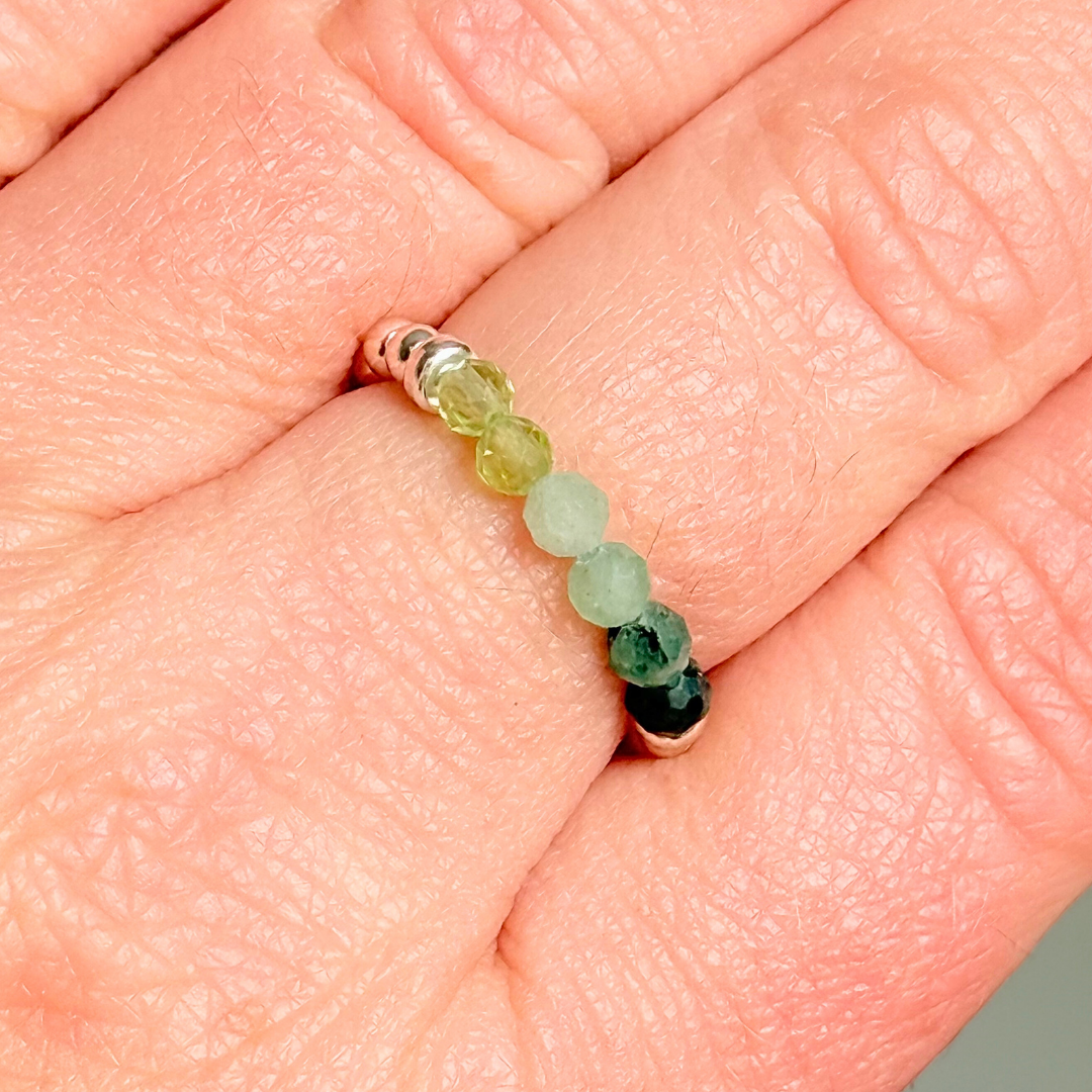 Sterling silver band style ombré ring with multicolour 3mm faceted peridot, green aventurine and emerald beads with a beaded band of 2.5 mm sterling silver round beads. Elasticated for comfort.