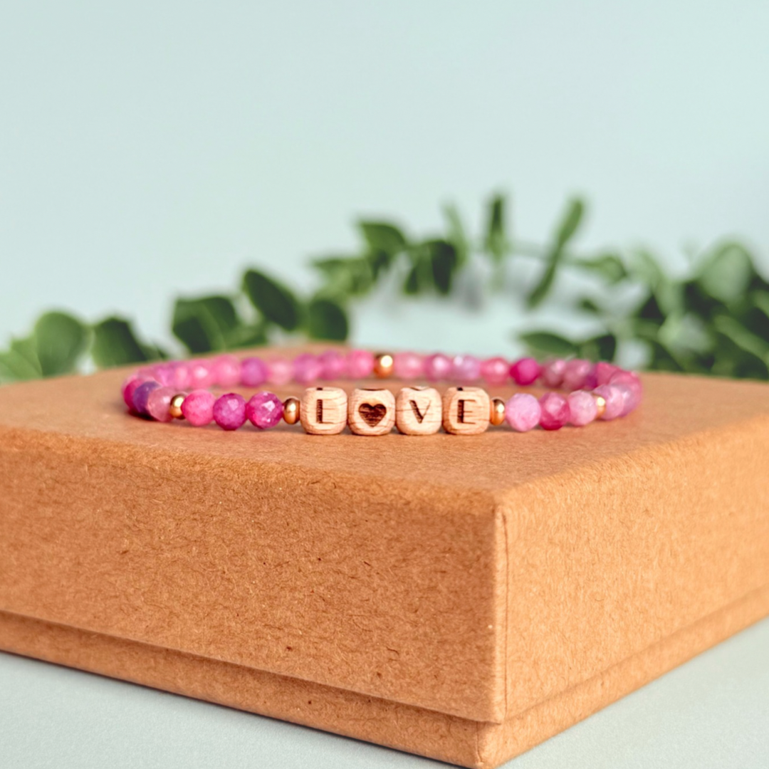Bracelet featuring 5mm engraved wooden beads which you can personalise with your choice of words, numbers and symbols. The main the band of the bracelet is made with 4mm faceted pink tourmaline round crystal gemstone beads. Finished with your choice of gold vermeil, sterling silver or rose gold vermeil accent beads.