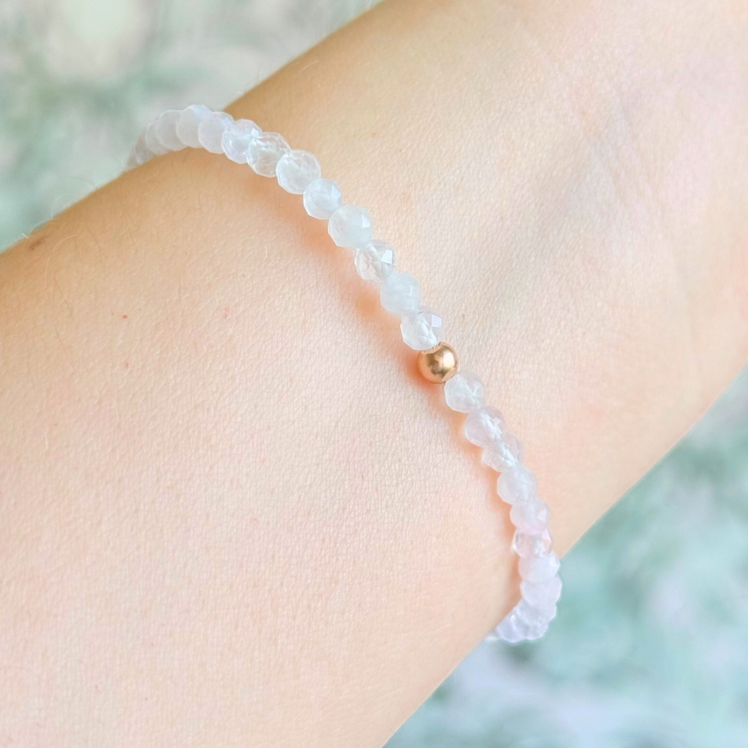 Bracelet featuring engraved wooden 666 angel number and wing beads, on the band of 4mm faceted rose quartz round crystal gemstone beads. Finished with your choice of gold vermeil, sterling silver or rose gold vermeil accent beads.